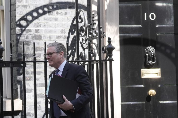 Keir Starmer exiting Number 10 Downing Street after a meeting, showcasing UK political leadership and discussions