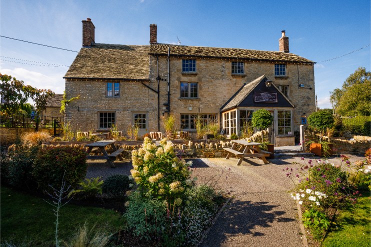 The Killingworth Castle in Cotswolds showcasing its historic architecture amidst scenic countryside surroundings