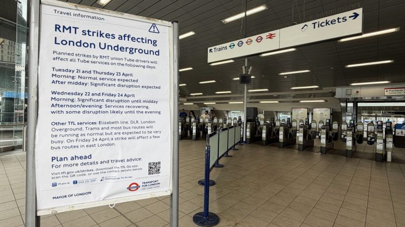 Crowded London Underground platform during tube strike with passengers waiting for limited train service amidst travel dis...