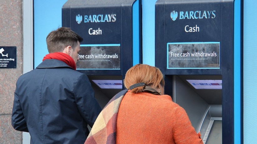 Barclays ATM machine exterior with bank branding and customer interface in a busy urban setting