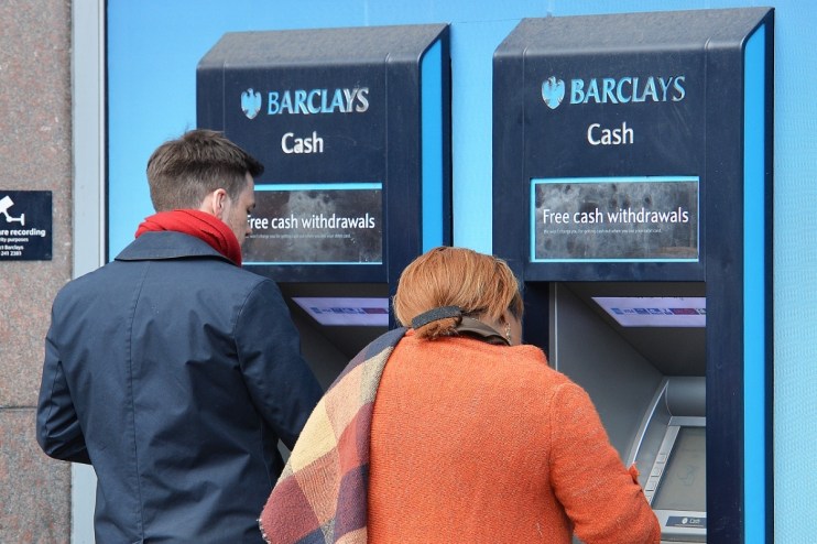 Barclays ATM machine exterior with bank branding and customer interface in a busy urban setting