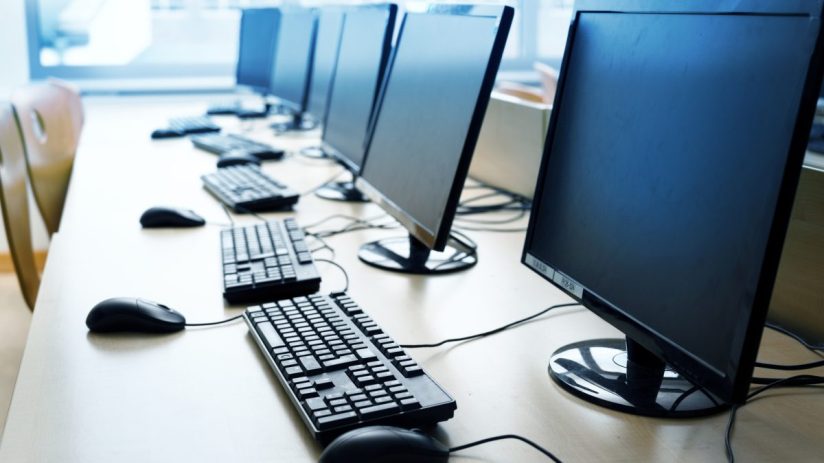 Modern computer workstation with sleek design, featuring dual monitors, ergonomic keyboard, and contemporary office decor.