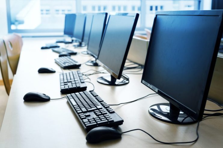 Modern computer workstation with sleek design, featuring dual monitors, ergonomic keyboard, and contemporary office decor.