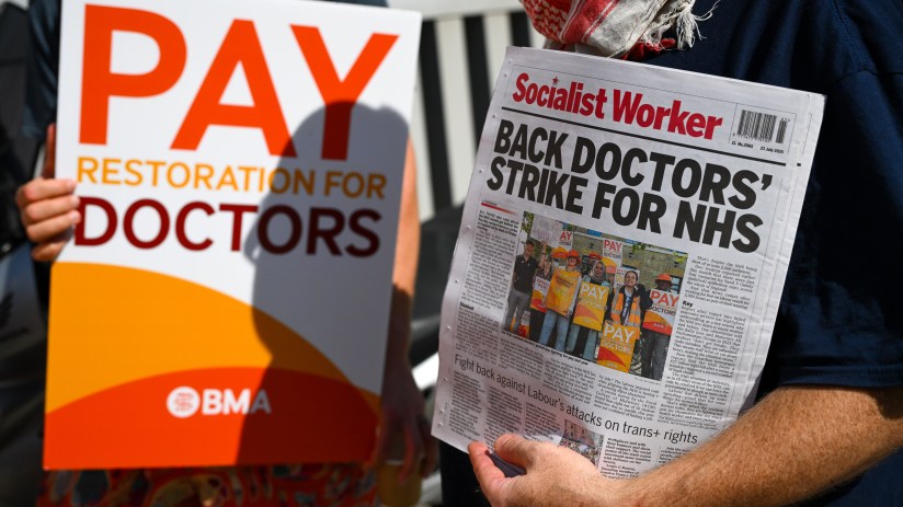 Doctors rallying with placards during a strike, advocating for better working conditions and fair wages in healthcare.