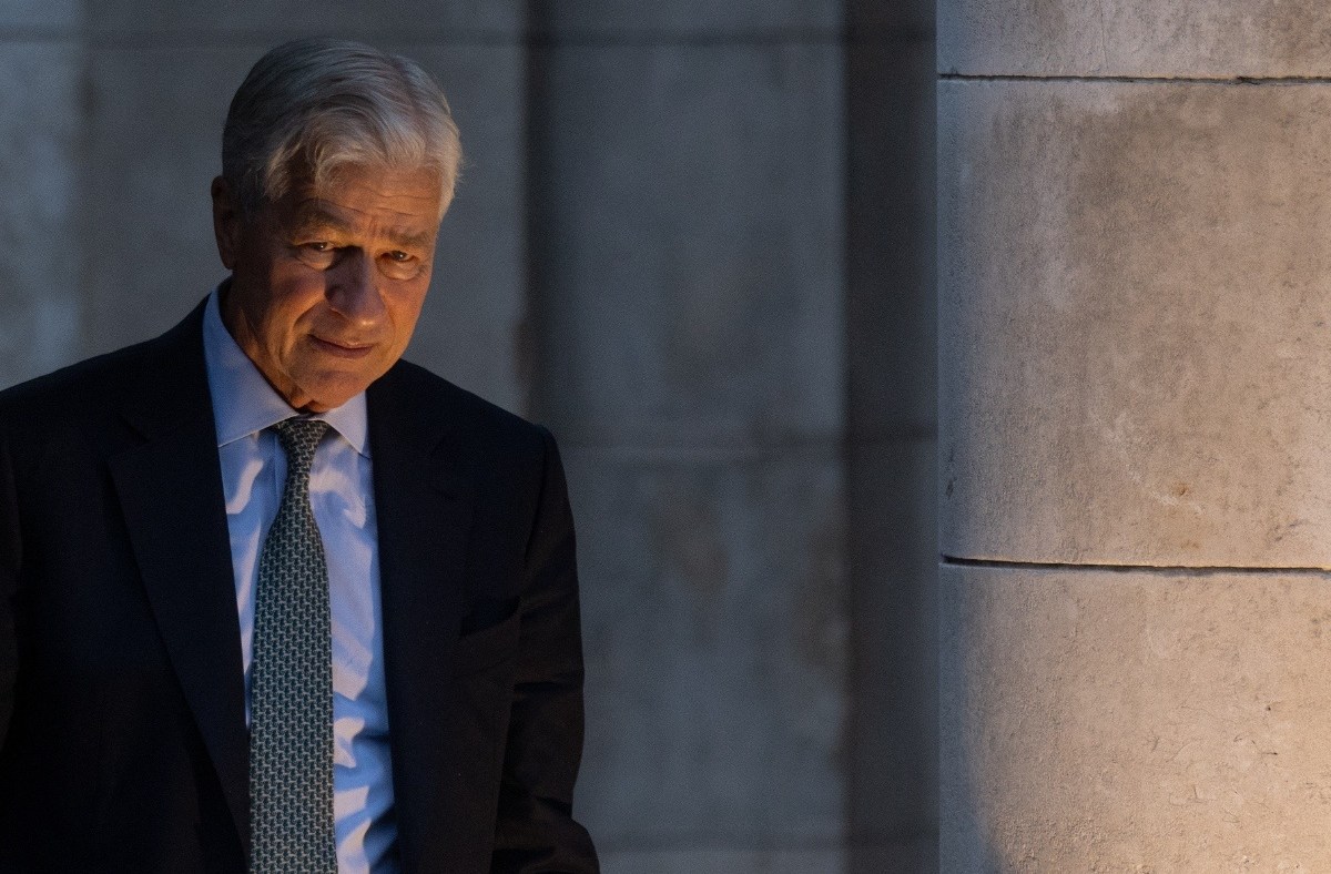 Jamie Dimon in a dark suit, serious expression, business setting, highlighting leadership in the financial industry