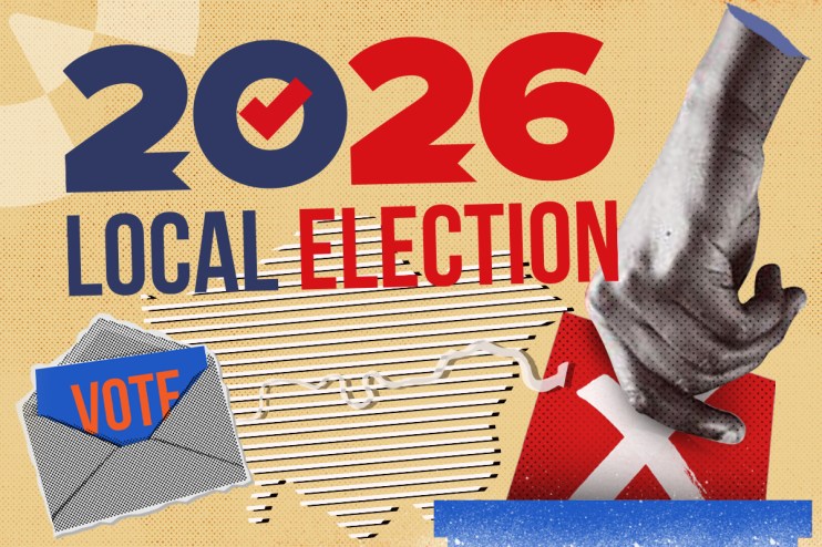 Voters casting ballots at a polling station in London during a local election, with people waiting in line.