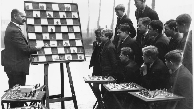 Young mentor guiding diverse group of teenagers in a collaborative workshop setting, emphasizing education and personal gr...