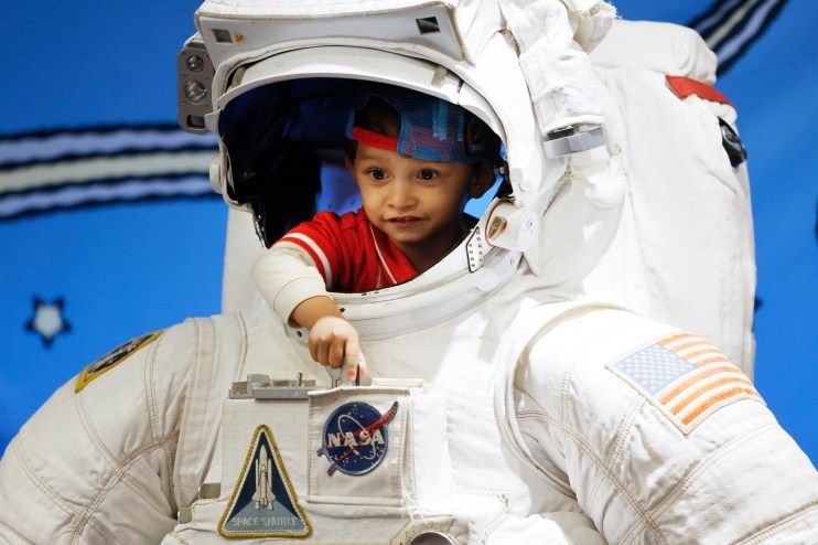 Astronaut floating in space with Earth visible in the background, highlighting the vastness of the universe and human expl...