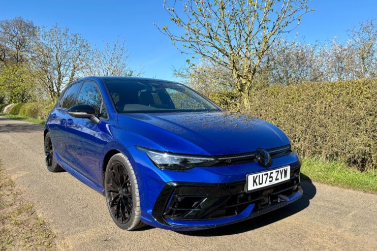 Volkswagen Golf R showcasing sleek design and sporty features on a city street for a news article about automotive trends.