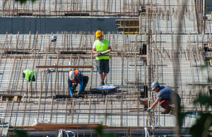 Construction site with cranes and scaffolding, showcasing urban development and building progress in a city environment