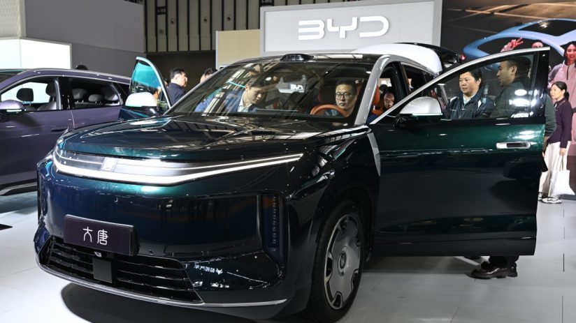 BYD electric vehicle displayed at an auto show featuring sleek design, showcasing the latest in green automotive technology