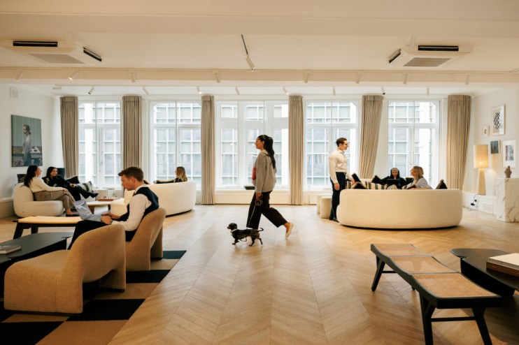 Halkin conference room with modern decor, large meeting table, and cityscape view through floor-to-ceiling windows