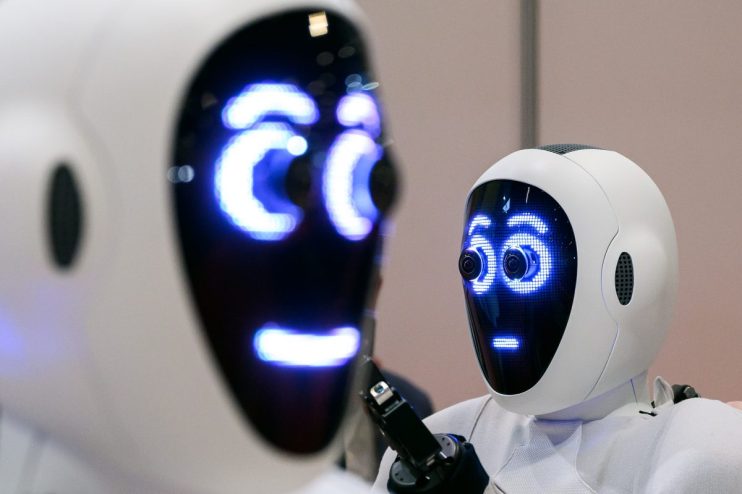 Advanced AI robots collaborating in a tech workspace, showcasing cutting-edge technology innovations in robotics