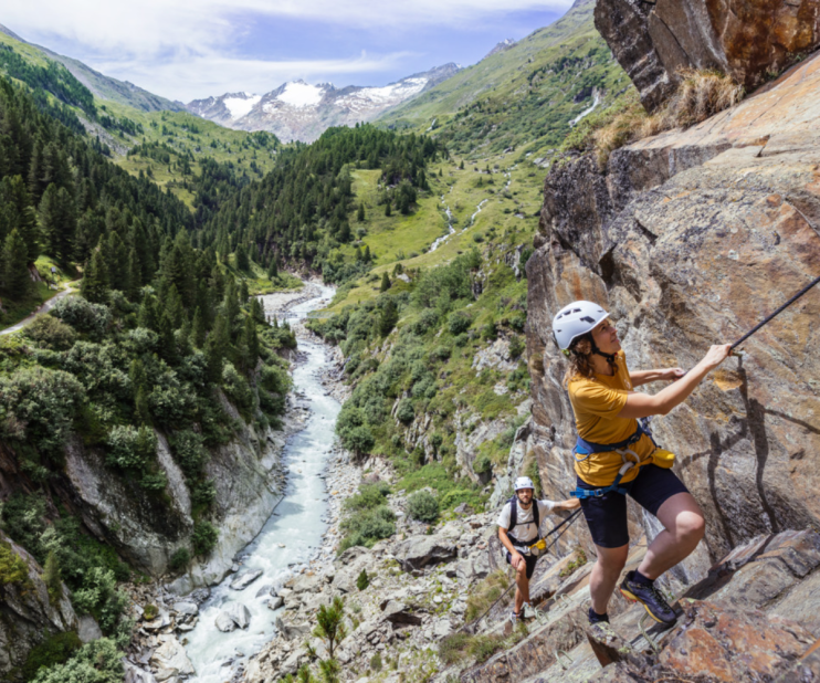 Breathtaking view of the Austrian Alps, featuring snow-capped peaks and lush greenery, ideal for adventure holidays.