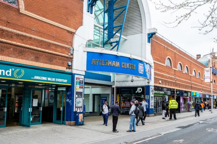 Aylesham Centre exterior view showcasing bustling shopping activity in the heart of the local community
