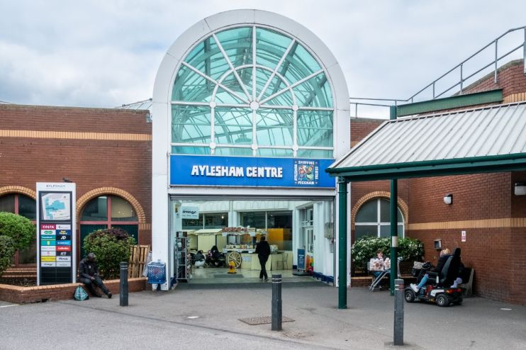 Aylesham Centre exterior view with shoppers and storefronts in bustling urban setting