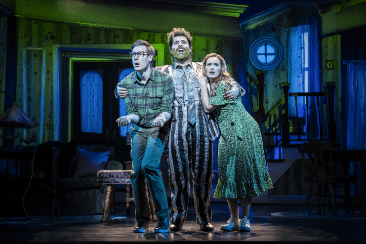 Beetlejuice musical cast performing on stage at the London production, showcasing vibrant costumes and set design