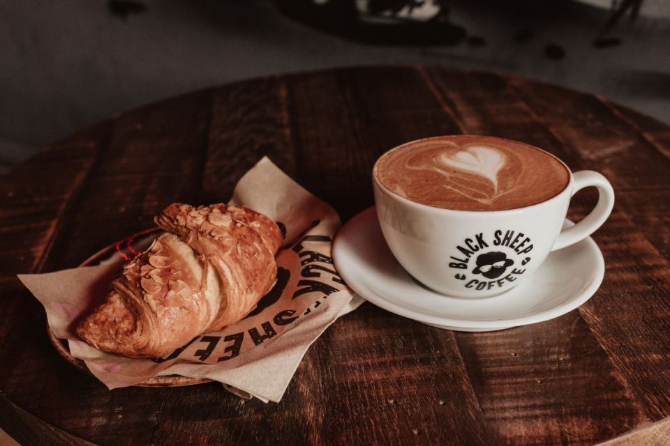 Black Sheep Coffee storefront showcasing modern design and inviting atmosphere in bustling city center