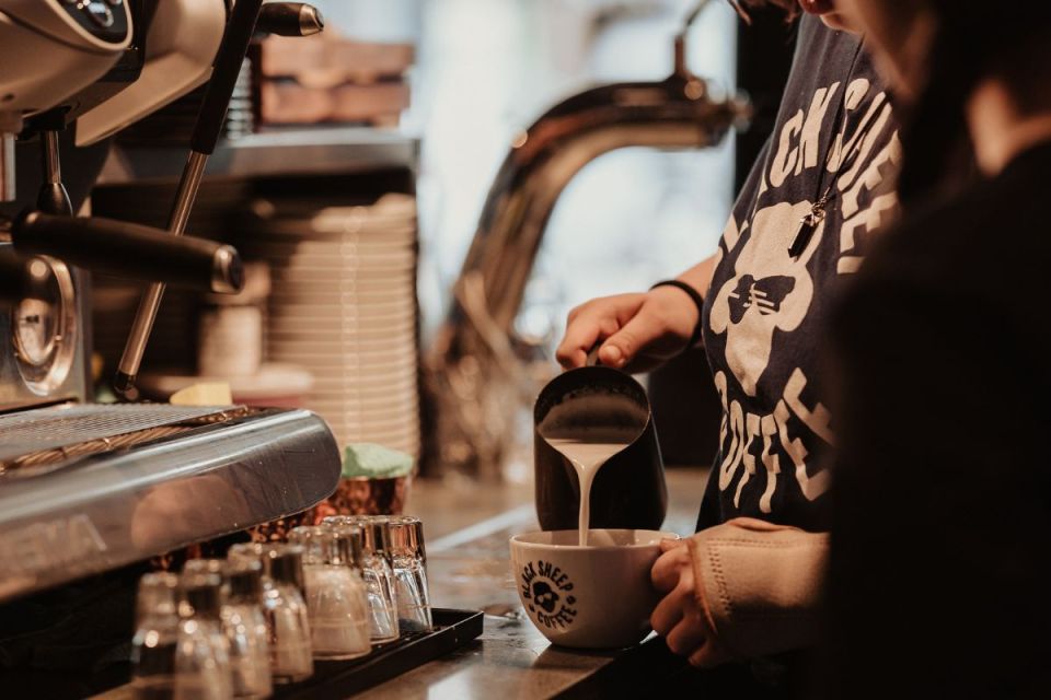 Black Sheep Coffee shop interior with modern decor, inviting atmosphere, and patrons enjoying specialty coffee beverages