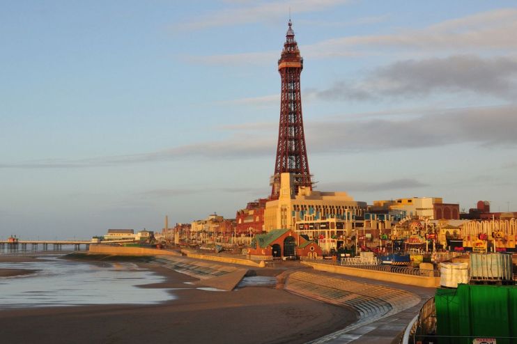 Blackpool skyline at sunset with iconic tower and bustling promenade, highlighting vibrant seaside town atmosphere