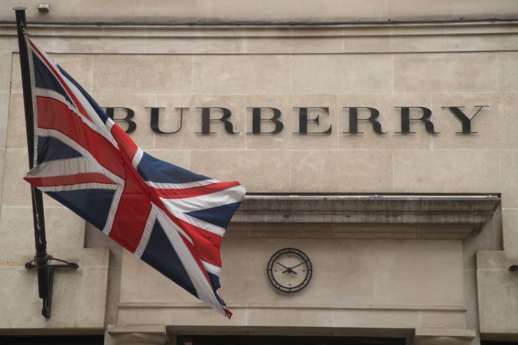 Burberry store showcasing elegant autumn collection with signature trench coats displayed in a chic retail environment