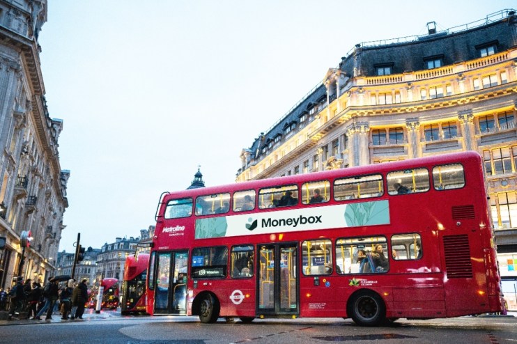 Modern city bus driving through urban streets, showcasing public transportation advancements in 2023