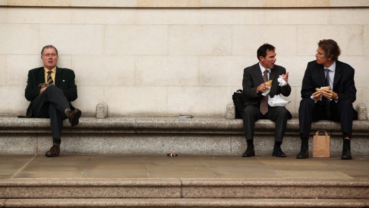 Businessman eating lunch outdoors in City of London financial district