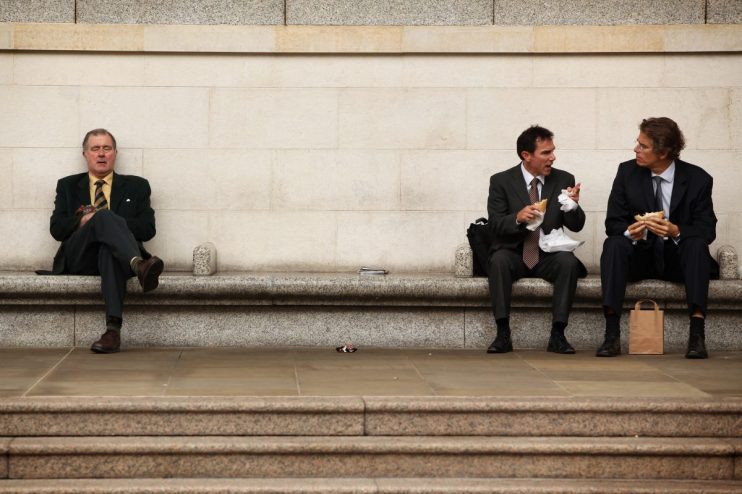 Businessman eating lunch outdoors in Canada financial district
