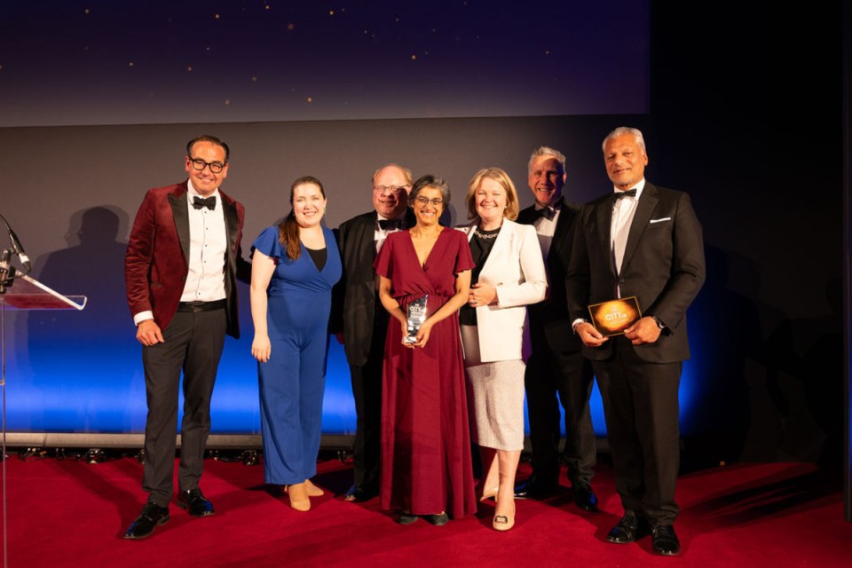 Hogan Lovells team celebrates Morning Wire Awards victory, showcasing joy and achievement in a prestigious business event setting