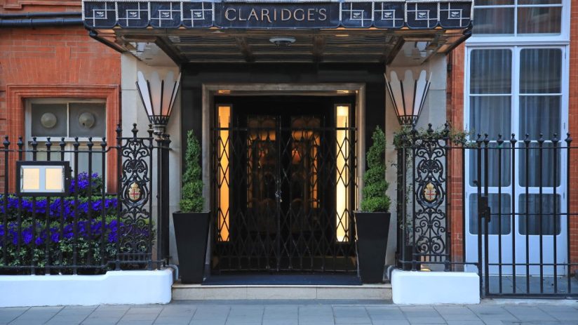 Claridges Hotel exterior showcasing elegant architecture with iconic entrance in a bustling city environment.