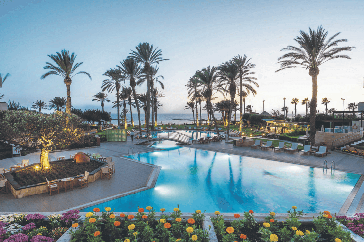 Scenic view of Cyprus coastline with sunny weather, traditional food, and refreshing drinks for travelers