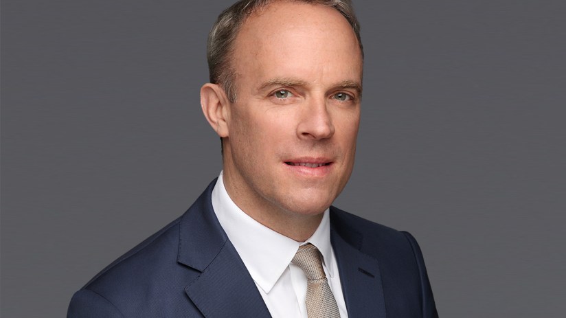 Dominic Raab headshot featuring a professional demeanor, wearing a suit and tie, against a neutral background.