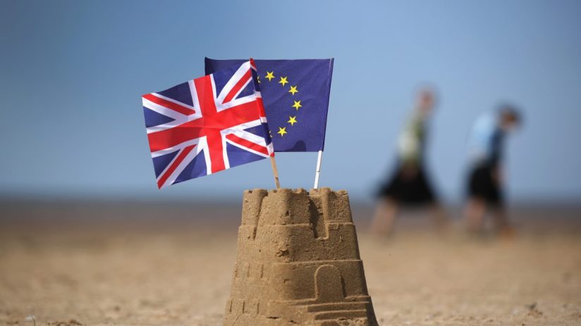 EU and UK flags intertwined symbolizing post-Brexit relations and ongoing diplomatic discussions
