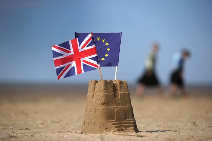 EU and UK flags intertwined symbolizing post-Brexit relations and ongoing diplomatic discussions