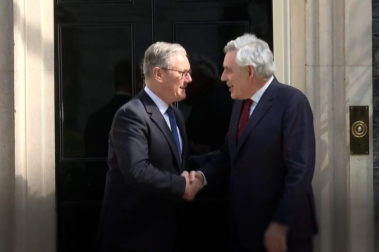 Gordon Brown and Keir Starmer engaged in discussion at a public event, emphasizing leadership and political strategy.