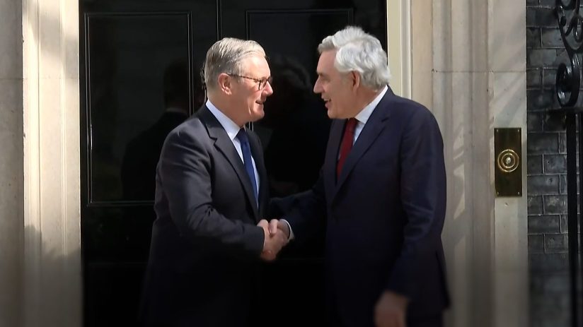 Gordon Brown and Keir Starmer engaged in discussion at a political event, highlighting leadership and policy collaboration