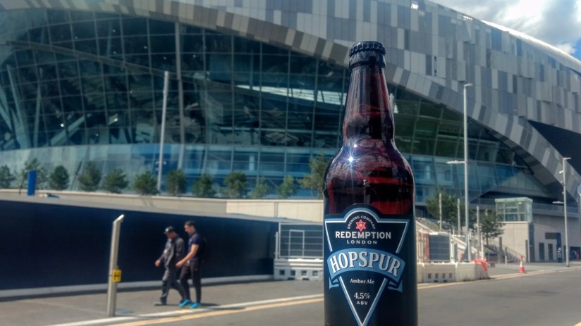 Hopspur Stadium exterior showcasing modern architecture and vibrant atmosphere on a bustling event day