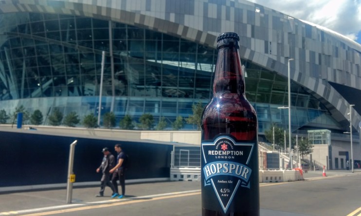 Hopspur Stadium exterior showcasing modern architecture and vibrant atmosphere on a bustling event day