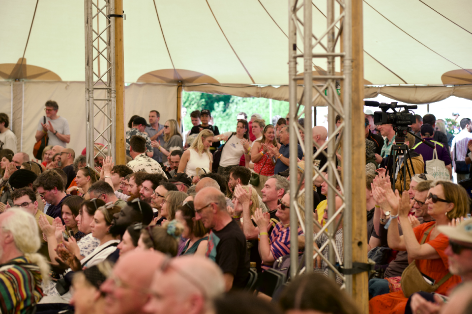 How The Light Gets In music festival crowd enjoying live performance with vibrant stage lights and outdoor festival atmosp...