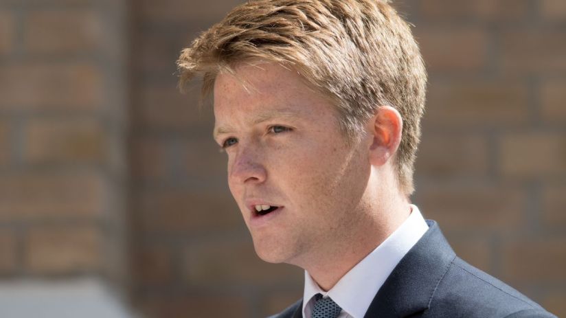 Hugh Grosvenor, dressed in a tailored suit, attending a high-profile business event, engaging with industry leaders.