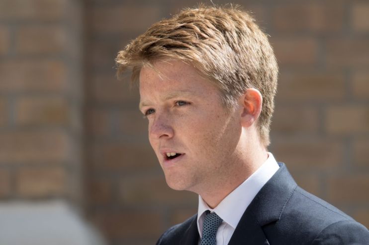 Hugh Grosvenor, dressed in a tailored suit, attending a high-profile business event, engaging with industry leaders.