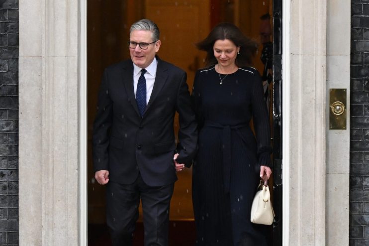 Keir Starmer stands outside 10 Downing Street amid calls for resignation, looking serious and contemplative