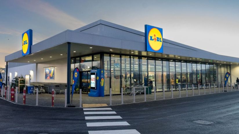 Lidl store entrance with shopping carts and customers entering on a busy day