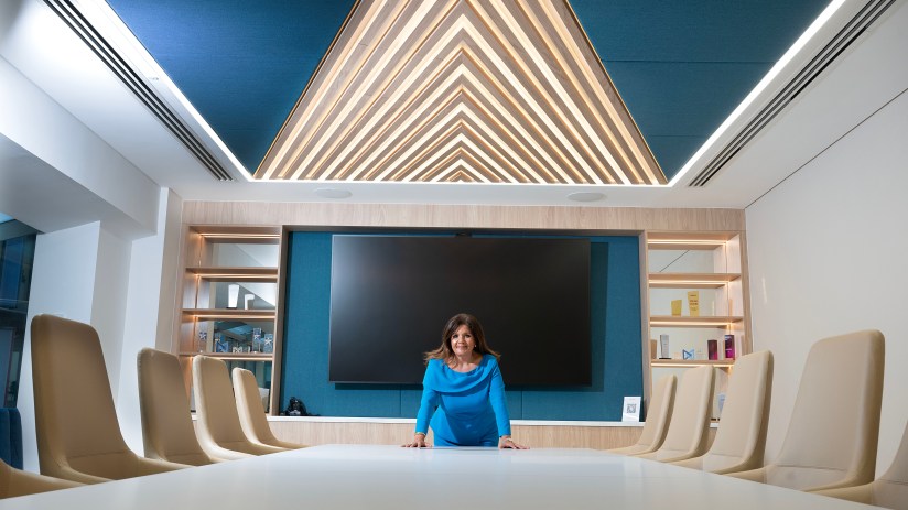 Mia Drennan, CEO of Glas II, smiling in a business suit, showcasing leadership and professionalism.