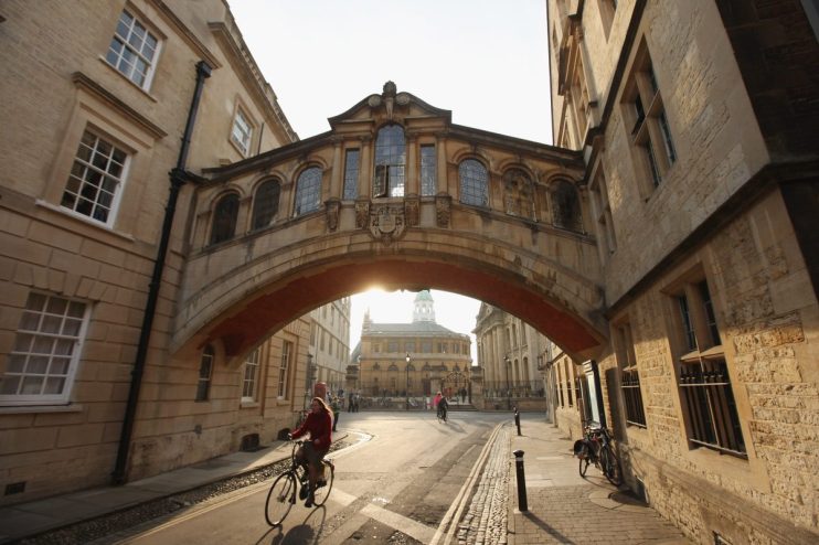 Oxford cityscape featuring historic architecture under clear skies, highlighting iconic landmarks and vibrant autumn foliage