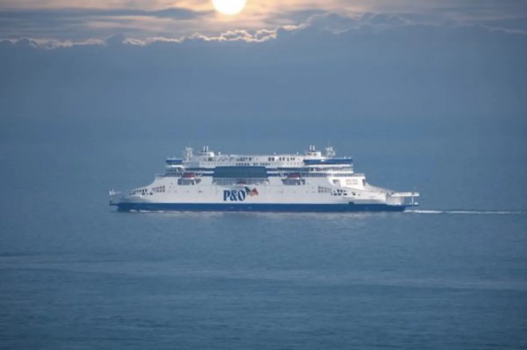 P and O ferry docked at a busy port under clear skies, highlighting maritime operations and transportation activities.