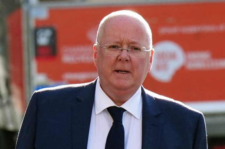 Peter Murrell at a press conference, addressing the media with a focused expression against a backdrop of journalists and ...
