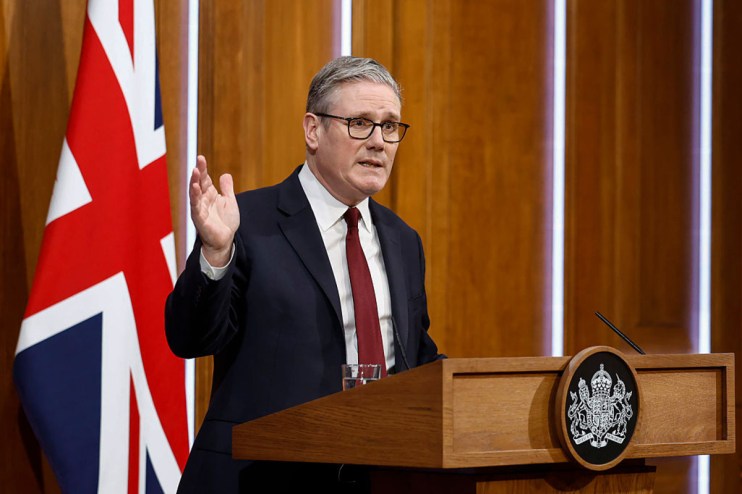 Prime Minister Keir Starmer addressing media at a press conference podium, discussing current governmental policies and in...