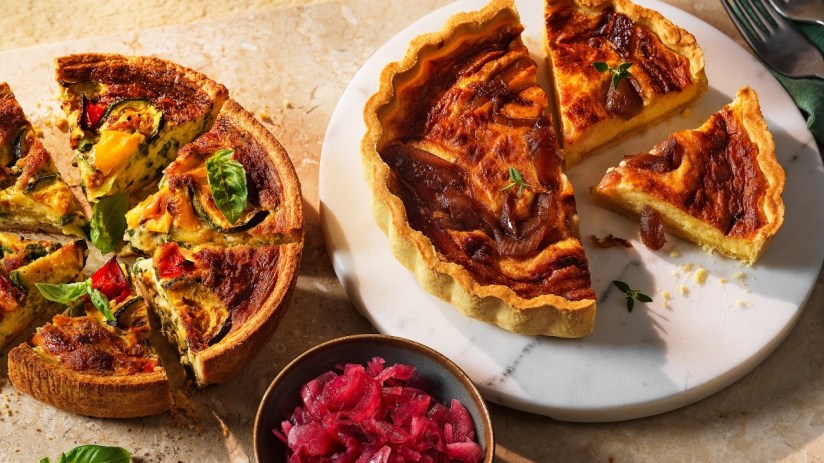 Golden-brown homemade quiche with flaky crust and vibrant vegetable filling, freshly baked and ready to serve.