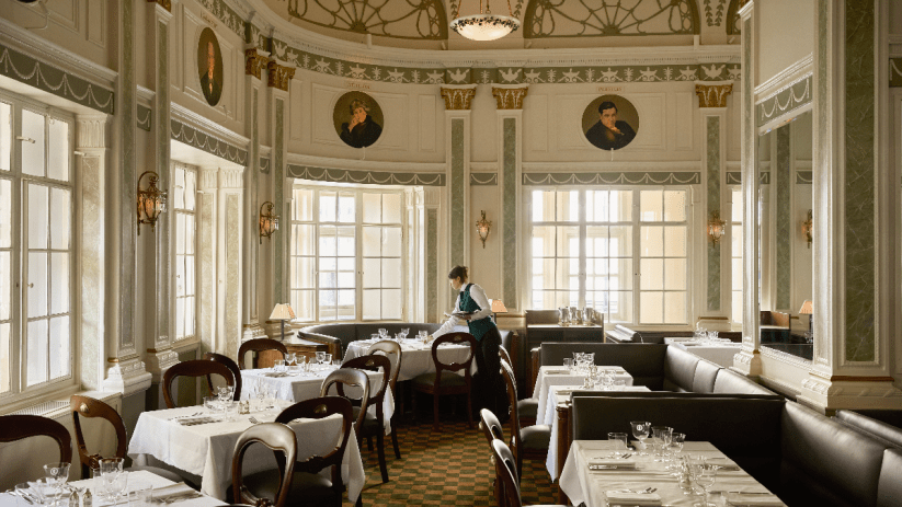 Romanos restaurant inside Simpsons in the Strand, featuring elegant decor and a vibrant dining atmosphere